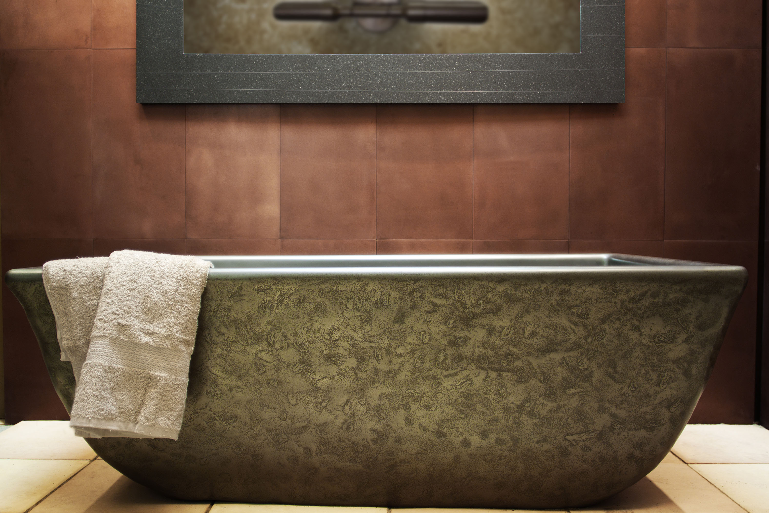 The Indulge Concrete Soaking Tub, MetalCrete Pewter Finish (Exterior Only) with Copper MetalCrete Pewter Cladding